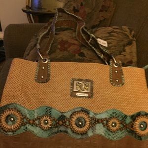 Tan purse by Sharif with green and brown accents.